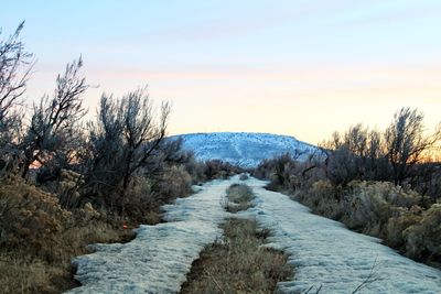 Scenic view of snow covered mountains against sky