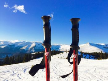 Snow covered field against blue sky