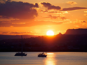 Scenic view of sea against romantic sky at sunset