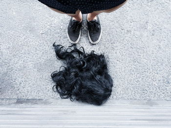 Low section of woman and wig