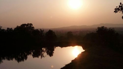 Scenic view of lake against sky during sunset