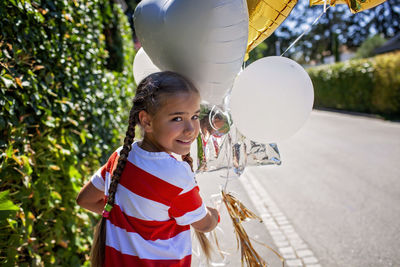 Portrait of cute girl holding umbrella