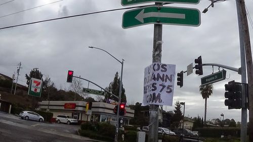 Low angle view of road sign against sky