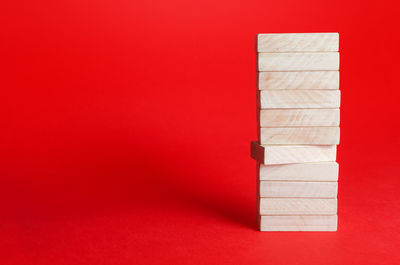 Close-up of wooden boxes on yellow background