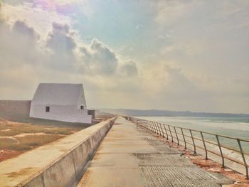 Narrow pathway along calm sea