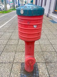 Red fire hydrant on footpath