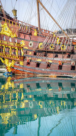 View of sailboats moored in water against sky