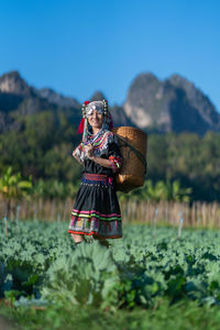 Woman standing on field against sky