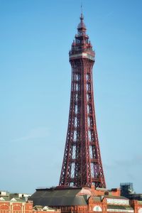 Low angle view of tower and buildings against sky