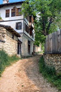 View of narrow alley amidst houses in village