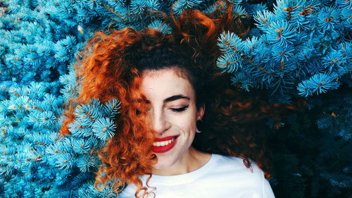 Smiling young woman amidst tree