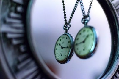 Close-up of pocket watches hanging at home