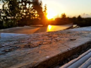 Surface level of snow against sky during sunset