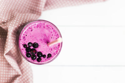 Close-up of smoothie with textile over white background