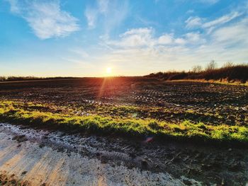 Scenic view of field against sky during sunset