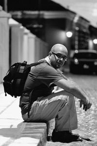 Side view of man on street at night