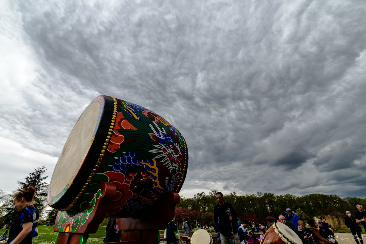 cloud - sky, sky, group of people, real people, day, multi colored, nature, leisure activity, people, crowd, celebration, outdoors, women, low angle view, lifestyles, overcast, men