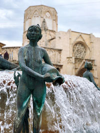 Statue against fountain