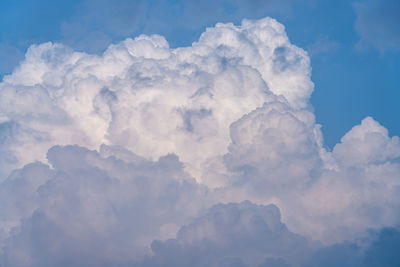 White cumulus clouds with blue sky background