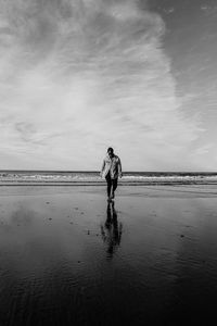 Full length of woman walking on shore at beach