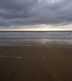 Scenic view of beach against sky during sunset