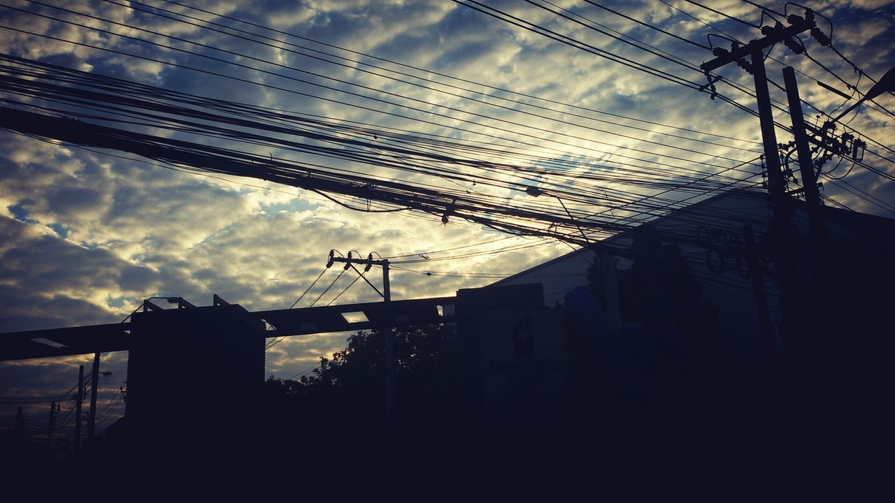 architecture, built structure, building exterior, sky, cloud - sky, cloudy, low angle view, cloud, silhouette, building, house, bare tree, power line, residential building, residential structure, no people, outdoors, city, electricity pylon, dusk