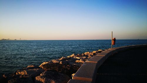 Scenic view of sea against clear blue sky