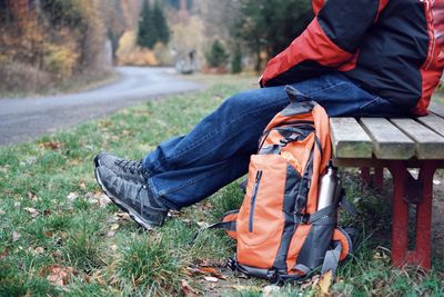 Low section of man sitting on bench