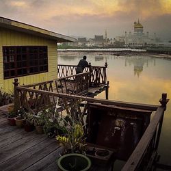 Pier on river at sunset