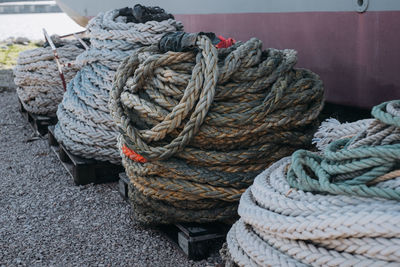 Close-up of rope tied to bollard at harbor