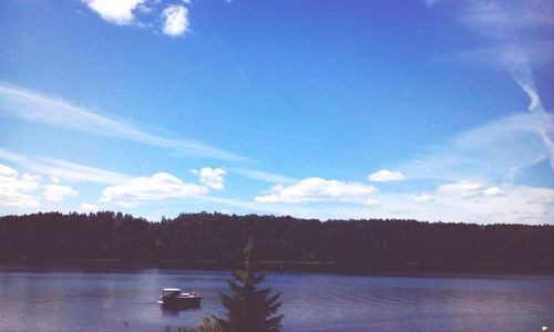 Scenic view of calm lake against cloudy sky