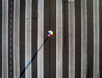 Aerial view of colorful umbrella on road during sunny day