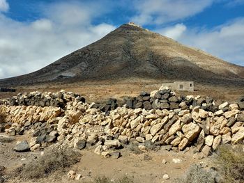 Scenic view of mountain against cloudy sky