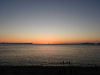 Scenic view of sea against clear sky during sunset