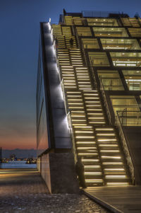 Staircase in city against sky