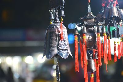 Close-up of bells hanging against blurred background