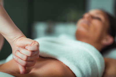 Massage salon, woman having a stomach massage.