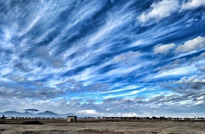 Scenic view of landscape against cloudy sky