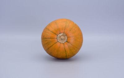 Close-up of pumpkin against blue background