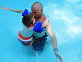 Boy and father in water