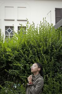 Woman standing by tree