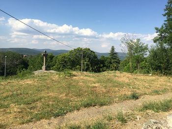 Scenic view of field against cloudy sky