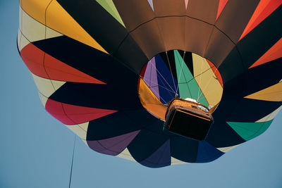 Low angle view of hot air balloon against blue sky