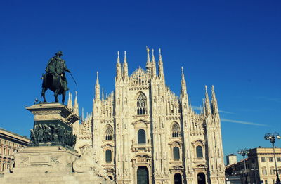 Low angle view of building against clear blue sky