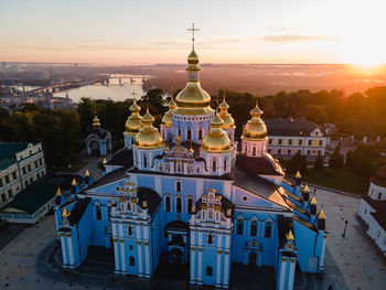 High angle view of buildings in city at sunset
