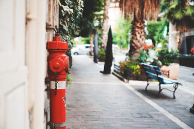 Red fire hydrant on footpath in city