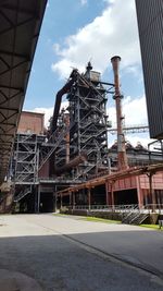 Low angle view of factory against sky