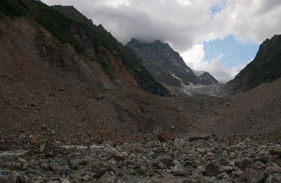 Scenic view of mountains against cloudy sky