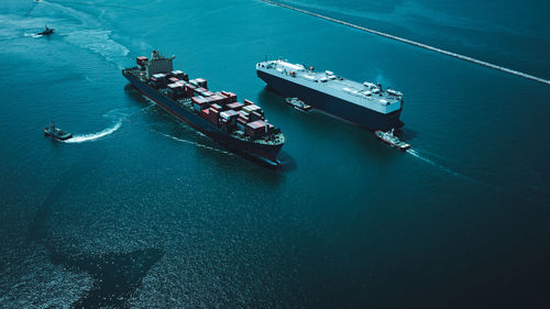 High angle view of shipping container sailing on sea