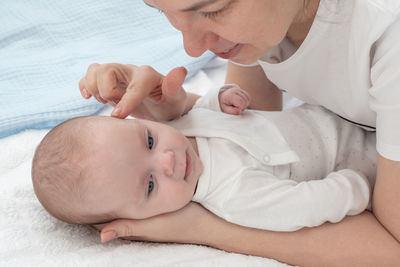 Midsection of baby boy sleeping on bed at home